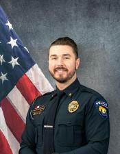Portrait of Jacob Glaser sitting in front of an American flag