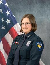Portrait of Briana Propson sitting in front of an American flag