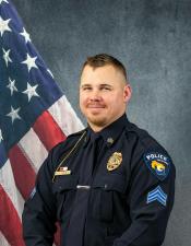 Portrait of Bradley Dimmick sitting in front of an American flag