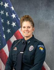 Portrait of Amanda La Tour sitting in front of an American flag