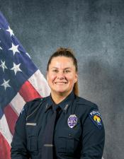 Portrait of Hailey Tobison sitting in front of an American flag