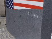 A granite memorial with the top half painted like the American flag with the date 5-5-1945