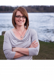 Smiling woman standing outdoors.