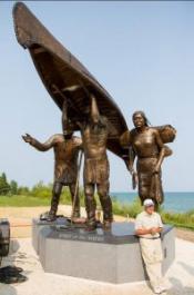 Artist Skip Wallen posing in front of Spirit of the Rivers monument
