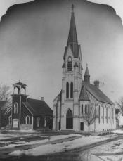 A black and white photo of St. John’s Lutheran Church with snow covering the ground
