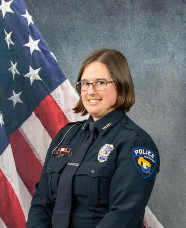 Portrait of Briana Propson sitting in front of an American flag