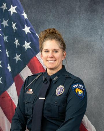 Portrait of Amanda La Tour sitting in front of an American flag