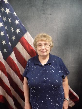 Portrait of Sharon Baetz with American flag in background