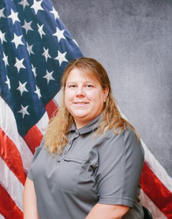 Portrait of Jodi Miller with American flag in background