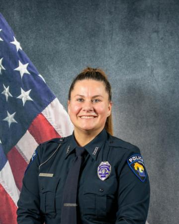 Portrait of Hailey Tobison sitting in front of an American flag
