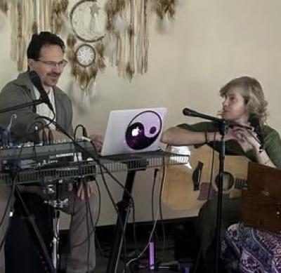 Man and woman with music equipment and microphone.