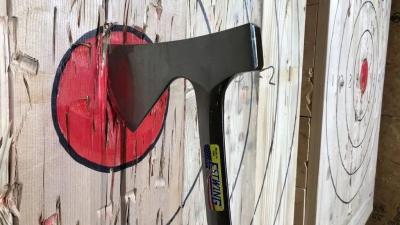 Axe hitting a red bullseye.
