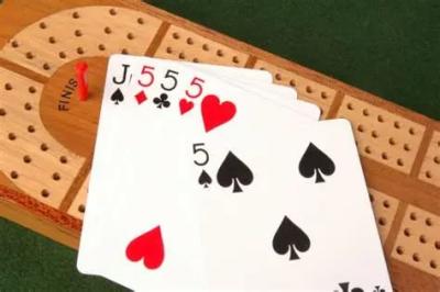 Playing cards upon a cribbage board.