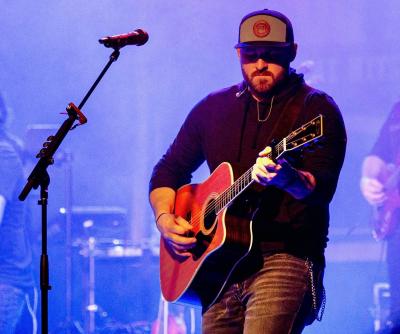 Man playing guitar onstage.