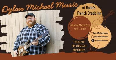 Smiling man holding a guitar.