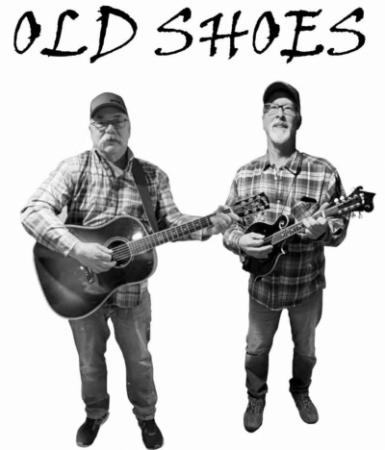 B/W image of two men holding guitars.