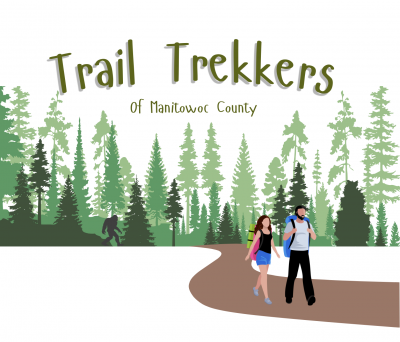 A man and woman hiking a trail emerging from a forest.