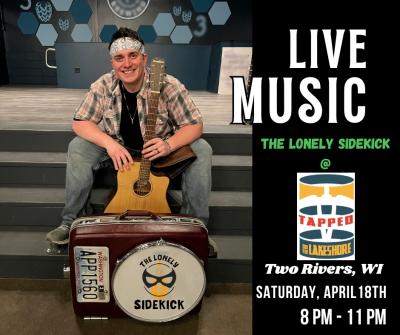 Smiling man sitting on steps holding guitar.