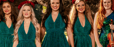 Performers in sparkly green gowns.
