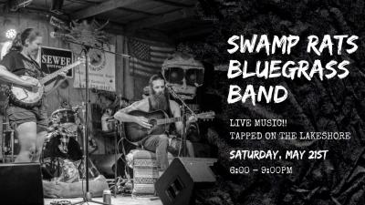 Woman playing banjo, a dog in a bed, a bearded man sitting and playing guitar.