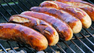 Brats on a grill.
