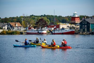 Paddlers in colorful kayaks.