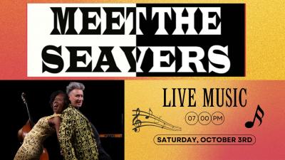 Man and woman happily performing onstage.