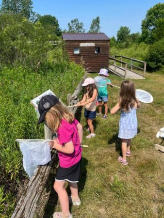 Group of young children exploring with bug nets.