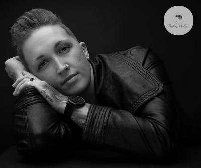 B/w image of Paulson leaning on hands and looking into camera.