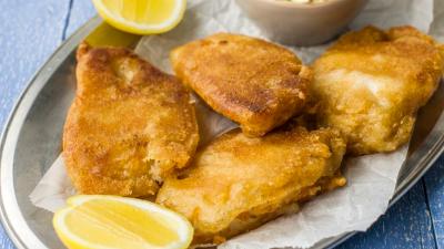 Plate of fish with lemon slices.