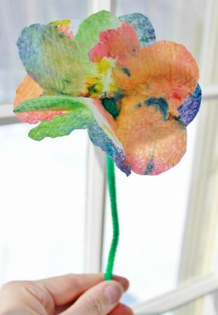 A single paper flower on a pipecleaner stem.