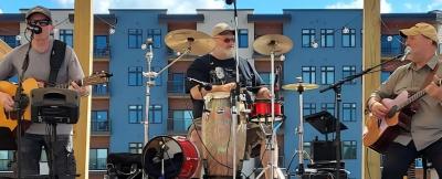 Three men performing onstage.