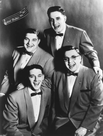 The four Schmidt brothers in suits and bow ties, b/w photo.