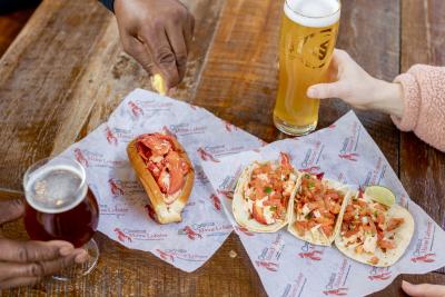 Glass of beer and lobster-filled items.