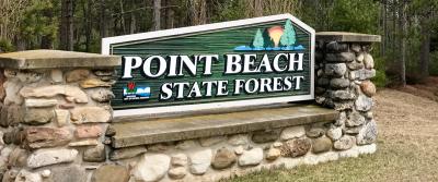 Sign between stone pillars announcing entrance to Point Beach State Forest.