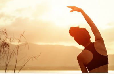 Person stretching on the beach.