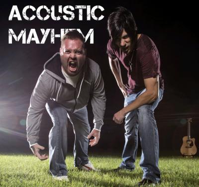 Two intense-looking dudes on a grassy field with a guitar standing in the background.