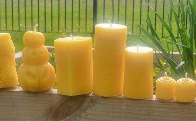 Row of yellow beeswax candles.