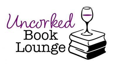 Glass of wine atop a stack of books.