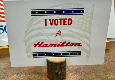 A wood-type printed sign reading "I voted at Hamilton."
