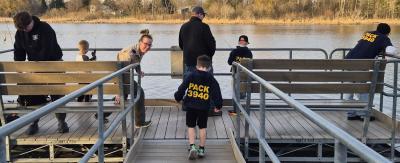 Group of all ages fishing from a pier.