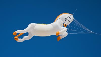 Horse kite flying in a blue sky.