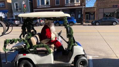 Santa driving a golf cart