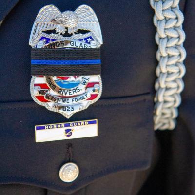Police officer's badge with black band around it.