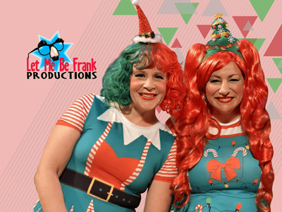 Two women dressed as Christmas elves.