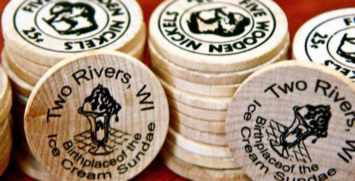 Multiple stacks of wooden chips that say "Five Wooden Nickels 25 Cents"