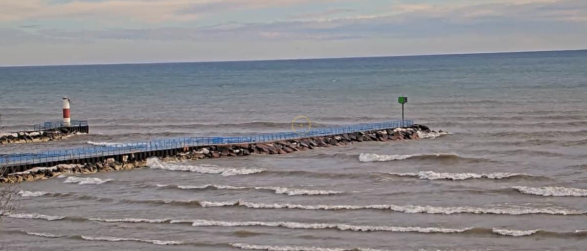 A view of Two Rivers Harbor with blue skies and fluffy clouds in the distance