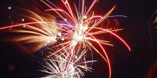 Fireworks exploding in the night sky.