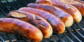 Brats on a grill.