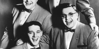The four Schmidt brothers in suits and bow ties, b/w photo.